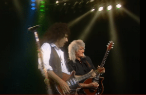 Brian May Performs With His Younger Self With “Back to the Light” Video