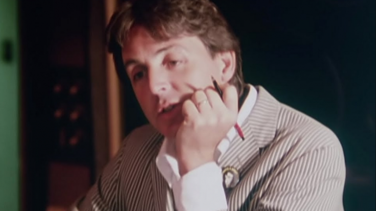 Paul McCARTNEY BEING INTERVIEWED with his face bowed in his hand.
