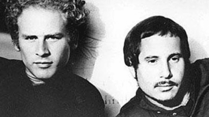 A black and white portrait of Simon & Garfunkel posing together.