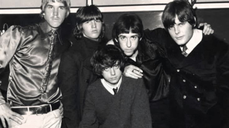 The Misunderstood, a 1960s psychedelic rock band, posing together in stylish attire with serious expressions.