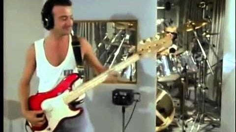 John Deacon playing one of his iconic Fender precision bass