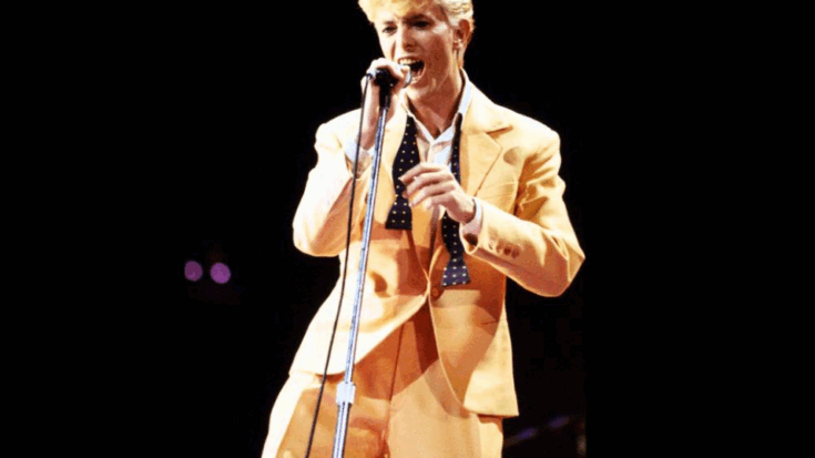 David Bowie performing live in 1983 wearing a bright yellow suit during his 
