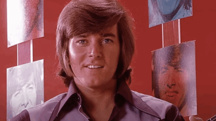 Bobby sherman holding a guitar and smiling