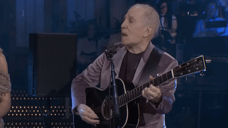paul simon Playing an acoustic guitar
