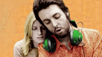 Paul McCartney and Linda McCartney embrace with headphones during the era of the RAM album
