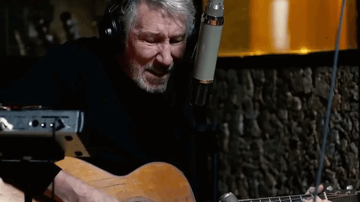Roger Waters performing acoustic guitar and vocals during an intimate studio session