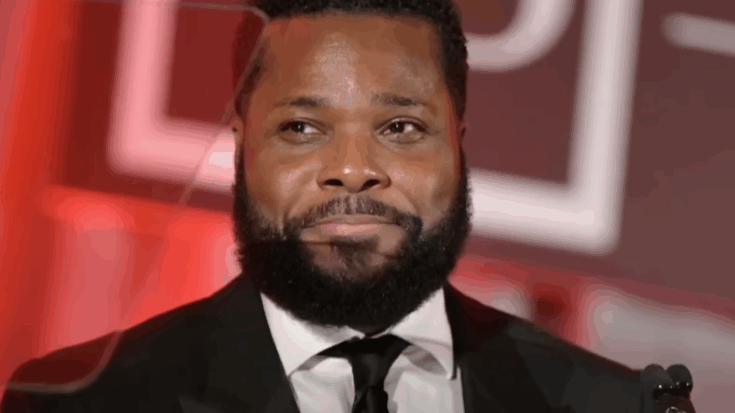 Malcolm-Jamal Warner wearing a suit