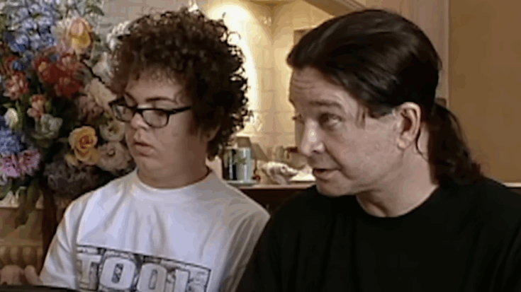 ozzy osbourne and his son sitting in front of the tv
