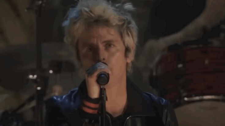 Billie joe Armstrong singing on a mic