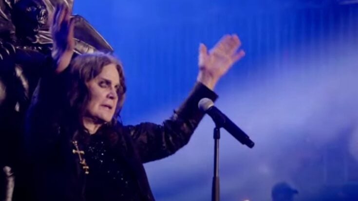 Ozzy osbourne with his hands raised