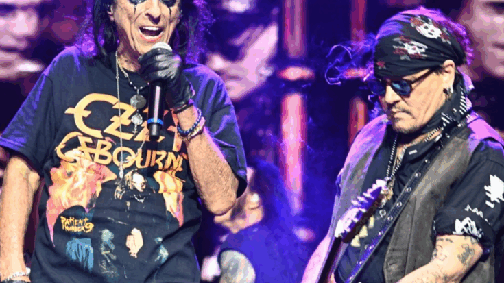 Alice Cooper passionately singing into a microphone while wearing an Ozzy Osbourne shirt, beside Johnny Depp playing guitar in a Ozzy tribute performance.