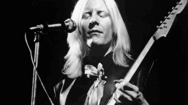 Johnny Winter playing electric guitar with closed eyes while performing live on stage