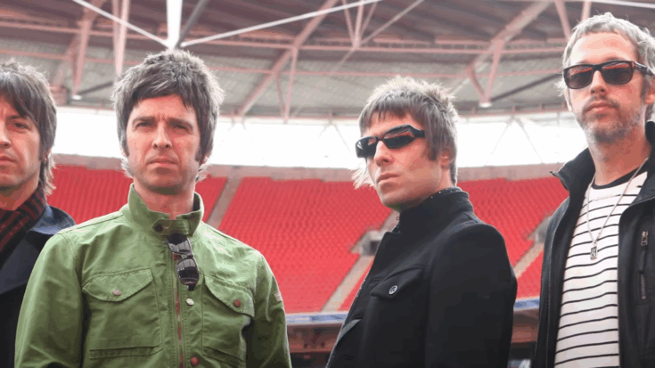 Oasis standing in a stadium