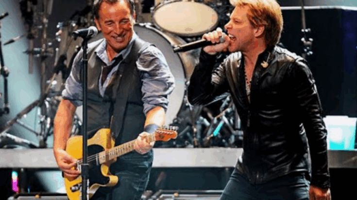 Bon Jovi performing on stage with Bruce Springsteen, singing and playing guitar together.