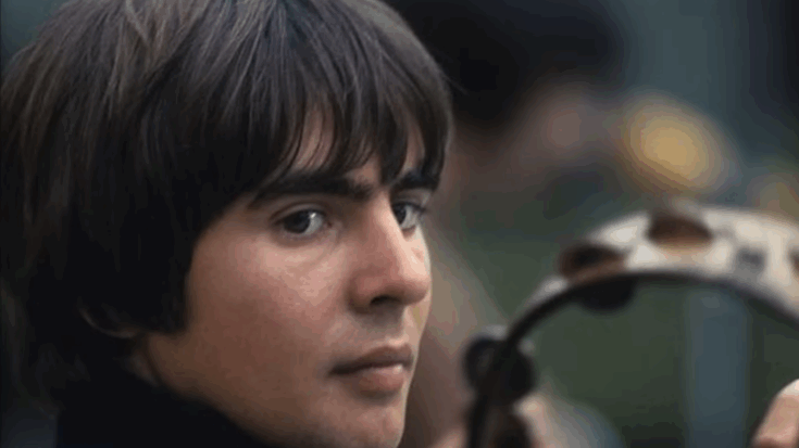 Davy Jones holding a tambourine and looking toward the camera.
