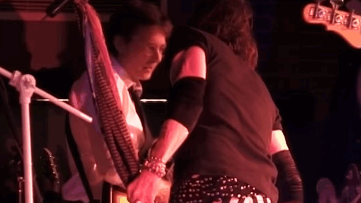 Michael J. Fox on stage playing guitar with Aerosmith during a live performance