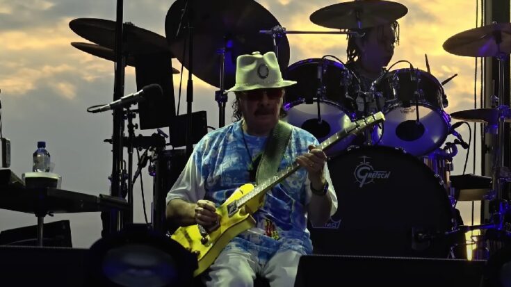 Santana wearing a polo shirt and playing his Gibson Les Paul