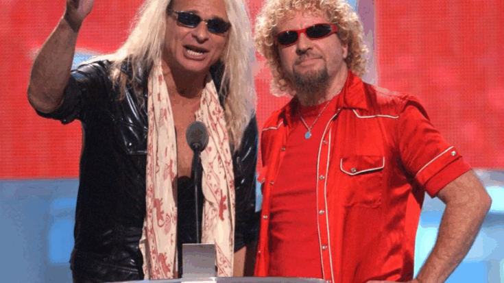 Sammy Hagar and David Lee Roth together on stage during 2002 VMAs, standing side by side behind a microphone stand.