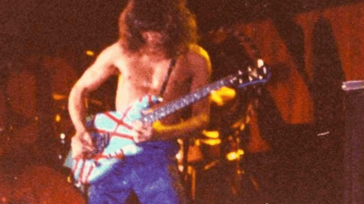 Van Halen guitarist performing shirtless on stage with a striped electric guitar in 1980