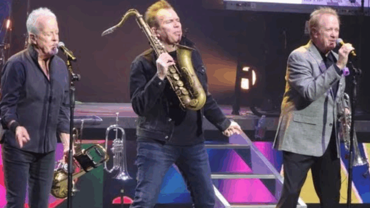 Chicago performing live during their Las Vegas residency at The Venetian on February 23, 2024, with band members playing brass instruments and singing on stage under colorful lights.
