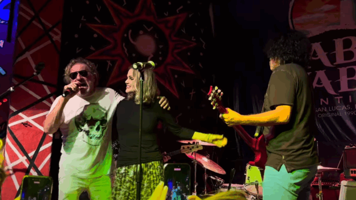 Sammy Hagar performs onstage with Belinda Carlisle and Steve Salas during his 2025 Birthday Bash celebration, surrounded by band members and vibrant stage lighting.