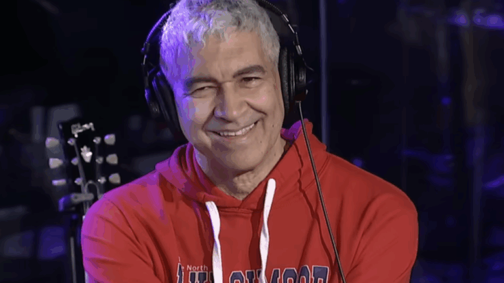 Pat smear smiling wearing a red jacket.
