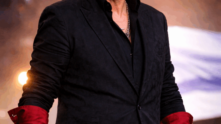 Roger Taylor wearing shaddes in a suit