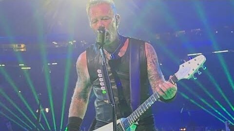 james Hetfield singing playing flyinf V guitar