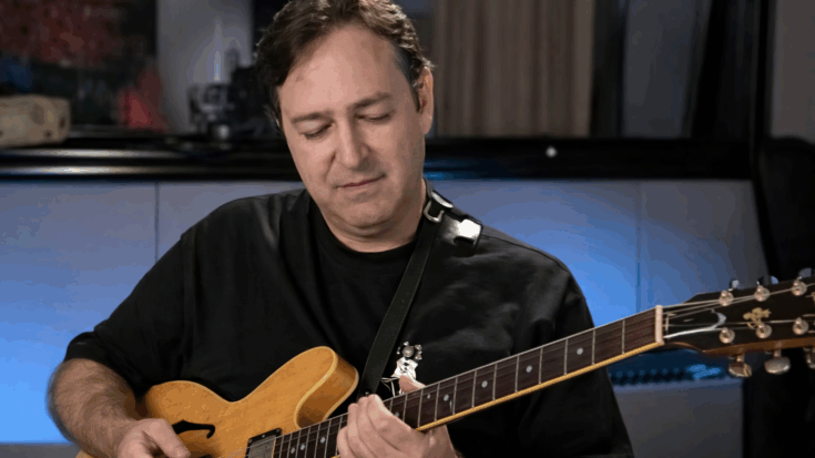 Wayne perkins playing a semi hollow guitar in an interview.