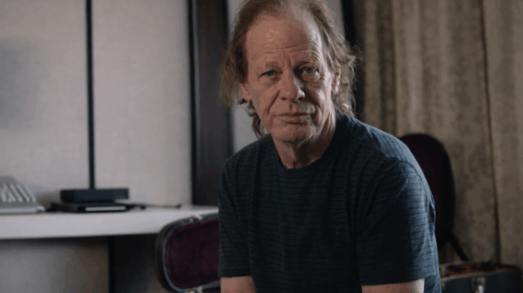 Stevie Young sits indoors with a calm, serious expression in a quiet interview-style setting.