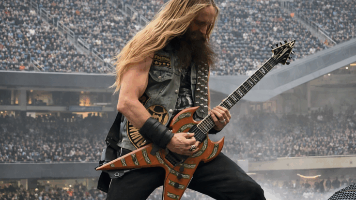 Zakk Wylde shreds onstage with his signature wild energy and a striking custom guitar.