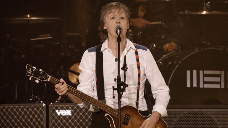 Paul McCartney sings onstage while playing his iconic Höfner violin bass.