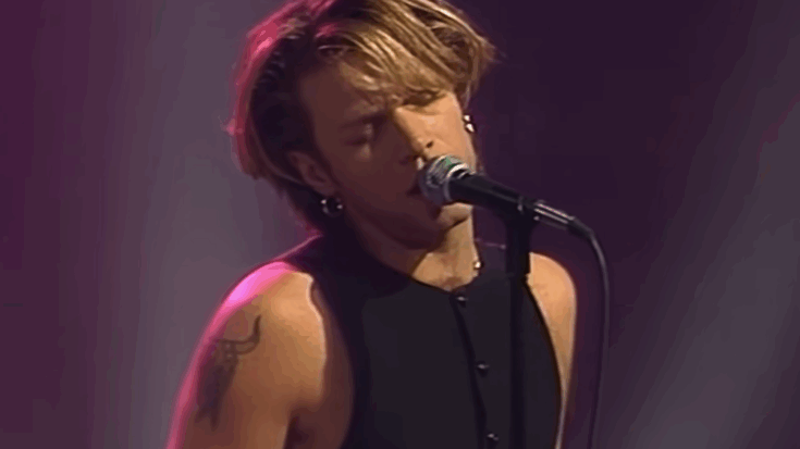 Jon Bon Jovi singing wearing a tank top.