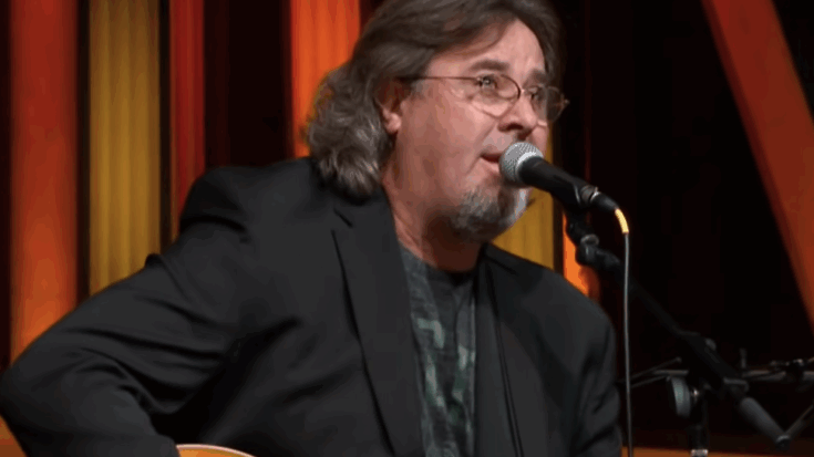 Vince Gill playing acustic guitar and singing. He's also wearing a tuxedo.