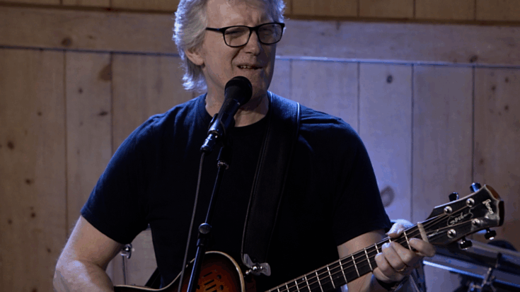 Rik Emmett playing his Godin acoustic guitar.