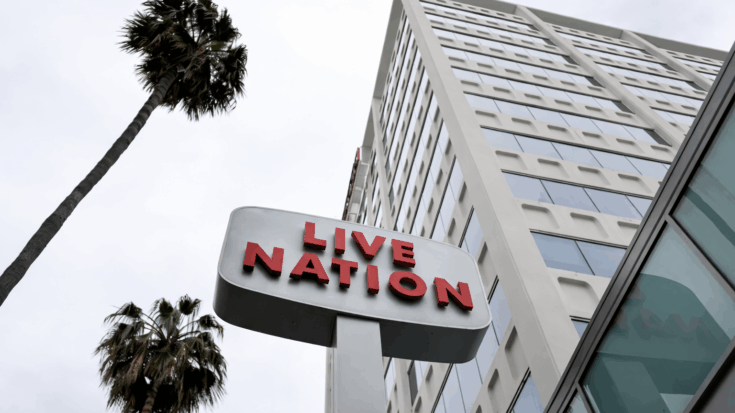 The Live Nation sign stands tall in bold red letters against a modern high-rise building and palm trees.