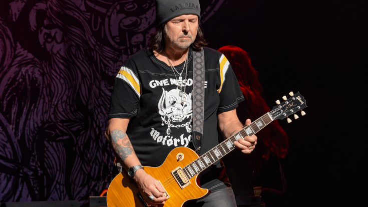 Phil Campbell plays his gold-top guitar onstage with a calm, focused rock-and-roll presence.