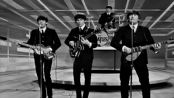 The Beatles perform together on a classic black-and-white television stage during their early years.